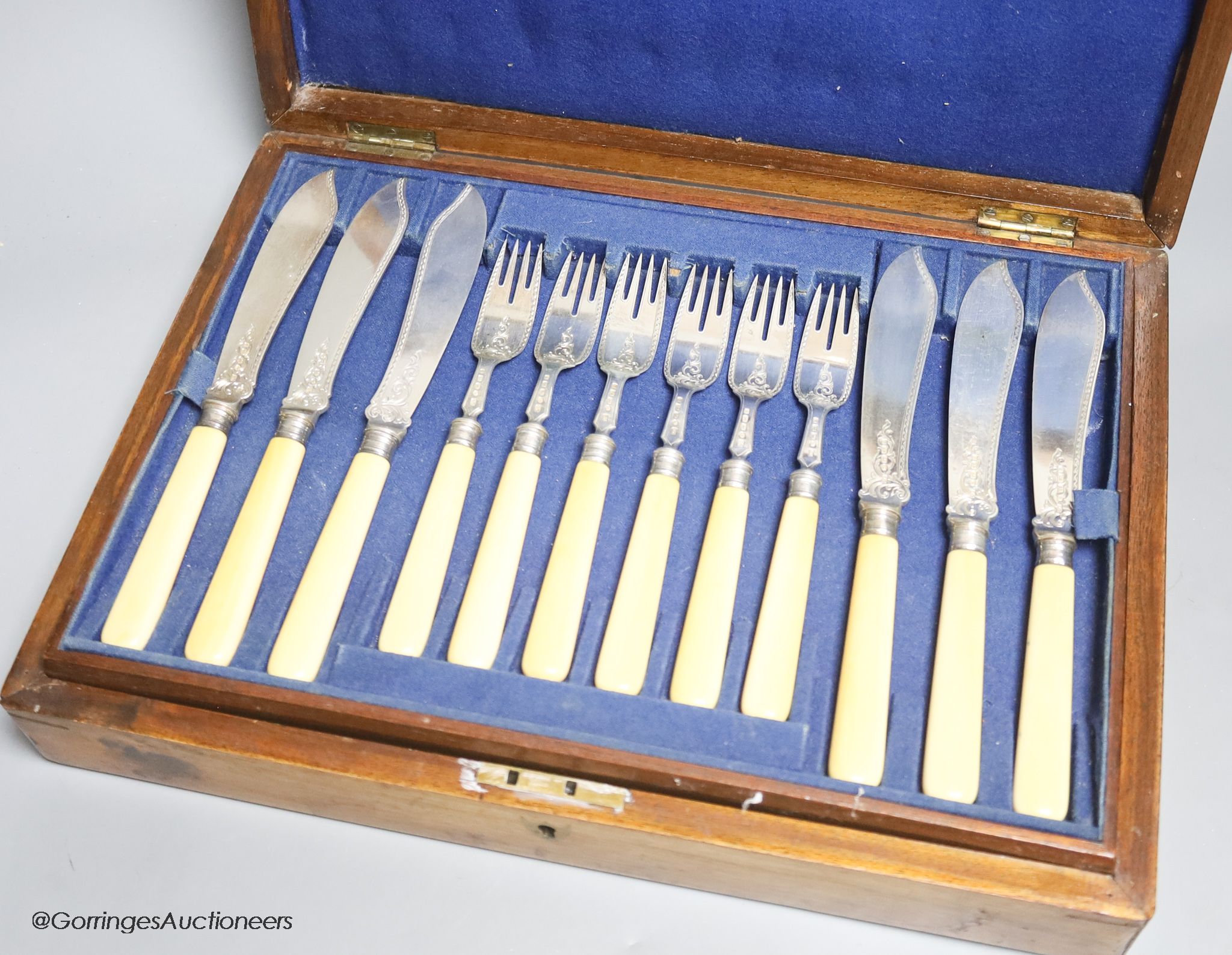 A Victorian cased set of eighteen pairs of ivory handled engraved silver fish eaters by John Gilbert & Co, Birmingham, 1874/5